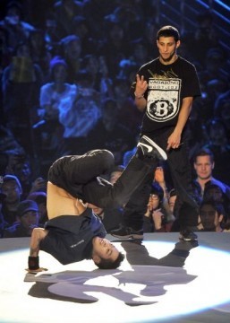 Hong-Yeol "Hong10" Kim (L) of South Korea performs as Monnir "Mounir" Biba (R) of France watches on during the Red Bull BC One World Final in Seoul on November 30, 2013. The breakdance competition, in which 16 of the world's best b-boys compete in one-on-one knock-out battle to determine who is the 'One', is in it's 10th year. Hong10 won the competition over Mounir in the final. ©AFP PHOTO / JUNG YEON-JE
