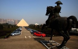 This picture taken on December 31, 2013, shows a 130-foot high pyramid (L) built by Chinese multi-millionaire Zhang Yue, on his corporate campus in Changsha, China's Hunan province. A Chinese multi-millionaire who built himself an Egyptian pyramid and a replica of Versailles vows to construct the world's tallest building in just six months -- despite authorities preventing work amid safety concerns. ©AFP PHOTO