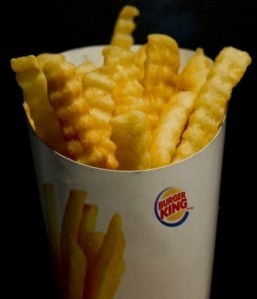 Satisfries, a new lower calorie and lower fat French fry from the fast food restaurant chain Burger King, appear in Washington, DC, September 24, 2013, on the first day of their release. The crinkle cut french fries, which are made of the same ingredients as regular fries, have 30 percent less fat and 20 percent fewer calories thanks to a change in the amount of some of the ingredients causing the fries to absorb less oil. A small serving has 270 calories and 11 grams of fat, compared to 340 calories and 15 grams of fat in Burger King's regular fries. ©AFP PHOTO / Saul LOEB