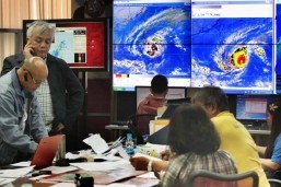 Weather forecasters monitor the progress of typhoon Ruby inside the PAGASA head office in Quezon City on Sunday. Ruby is slowly making its way through central Philippines in a west-northwest direction at 15 kilometers per hour, and is expected to pass near Metro Manila on Monday. (MNS photo)