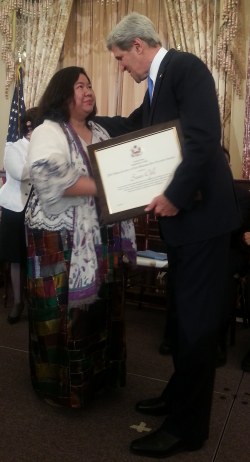 US Secretary of State John Kerry hands over the “2013 Hero Acting To End Modern-Day Slavery Award” to OFW advocate Susan Ople
