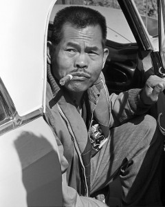 California:. Larry Itliong, arriving at AWOC meeting in Central Valley, sitting in a car with the door open, smoking a cigar. Early 1960's. ©1976 George Ballis/Take Stock / The Image Works "The Image Works" (photo courtesy of http://www.delanomanongs.com/)