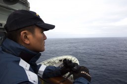 Malaysian aircraft March 24, 2014 – Able Seaman Januario Callos keeps watch on the starboard bridge-wing of HMAS Success during the search for the missing Malaysia Airlines Flight MH370. The supply ship will use visual lookouts and is equipped with radar and communications equipment to support a coordinated search with other assets within the area. With a displacement of 18 thousand tonnes and carrying a crew of 218, HMAS Success is one of the RAN's largest vessels, capable of providing a valuable surface search, investigation and recovery capability to support the ADF air operations. Photo: LSIS James Whittle aboard HMAS Success/Commonwealth of Australia, Department of Defence