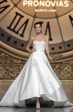 The “Vitality” dress by Atelier Pronovias - Collection 2016 Princess-style wedding dress in lace and Mikado Silk, with a bustier and a short-front, long-back voluminous skirt and narrow belt. ©Atelier Pronovias