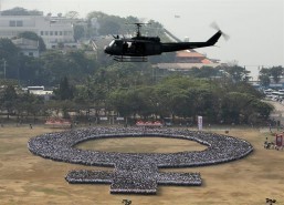 A helicopter hovers above a large human women symbol at the Quirino Grandstand on the celebration International Women's Day in Manila, the Philippines, 08 March 2014. According to the Philippine Commission on Women, more than 10,000 participants join the human formation to set a new Guinness World Record as the 'Biggest human formation on women's symbol'. (MNS photo)